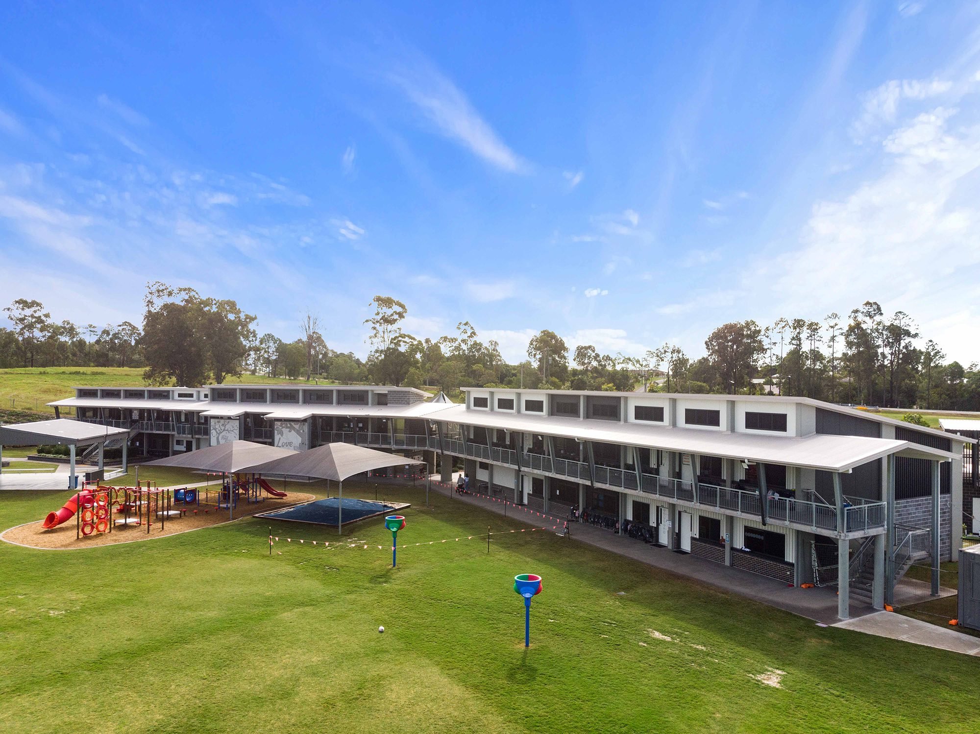 Aerial view of a school campus with play areas and covered walkways