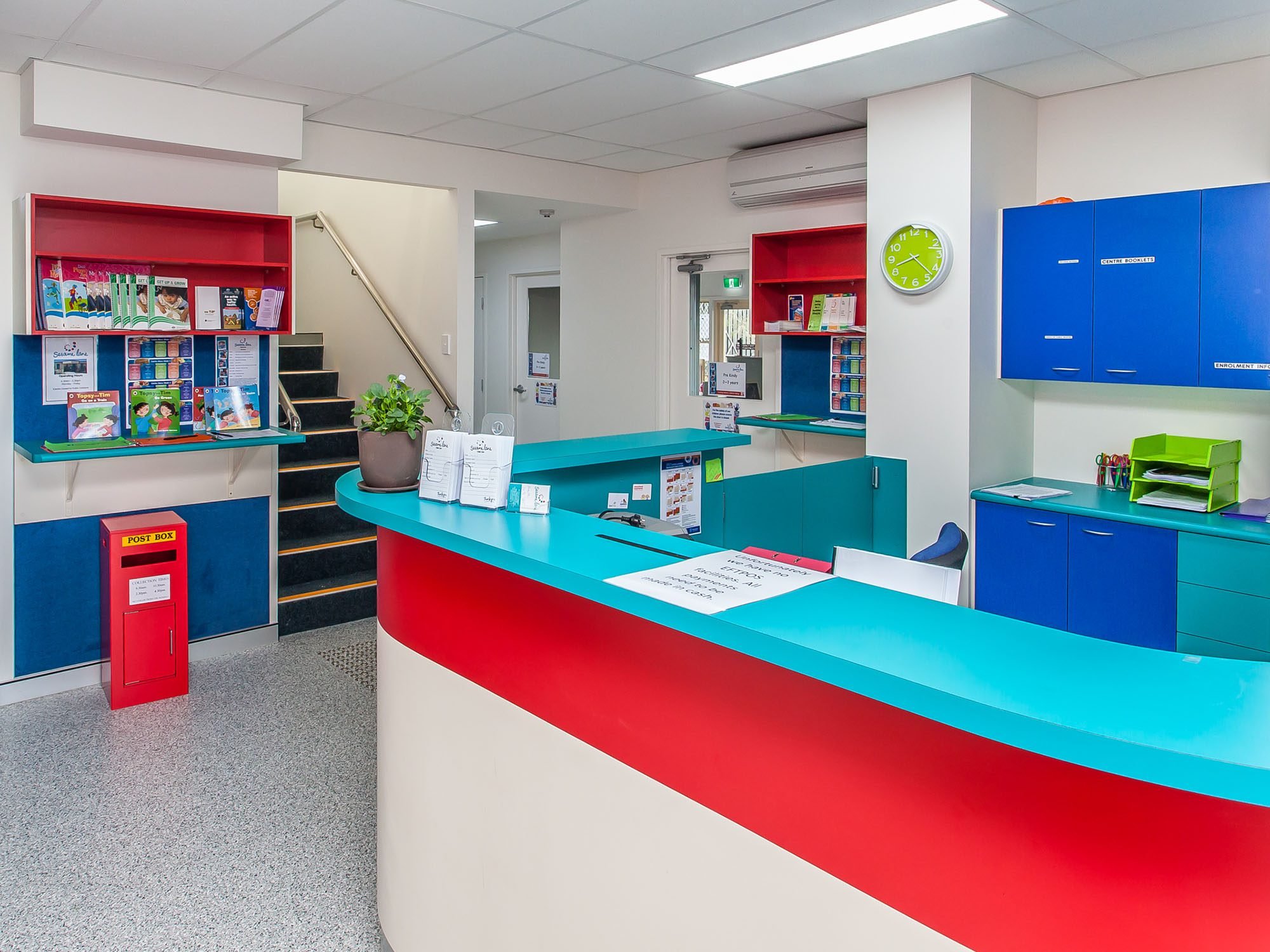 Reception desk with bright colour blocking and downlighting