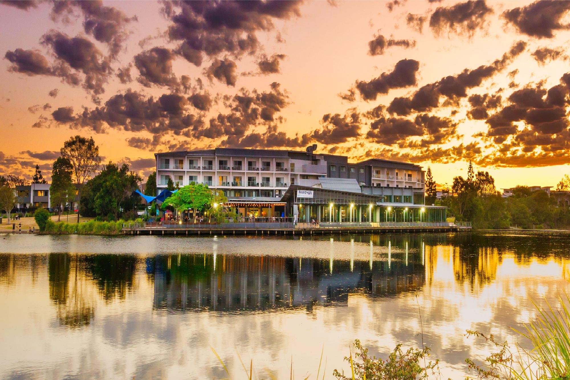 Hotel illuminated at sunset across the lake