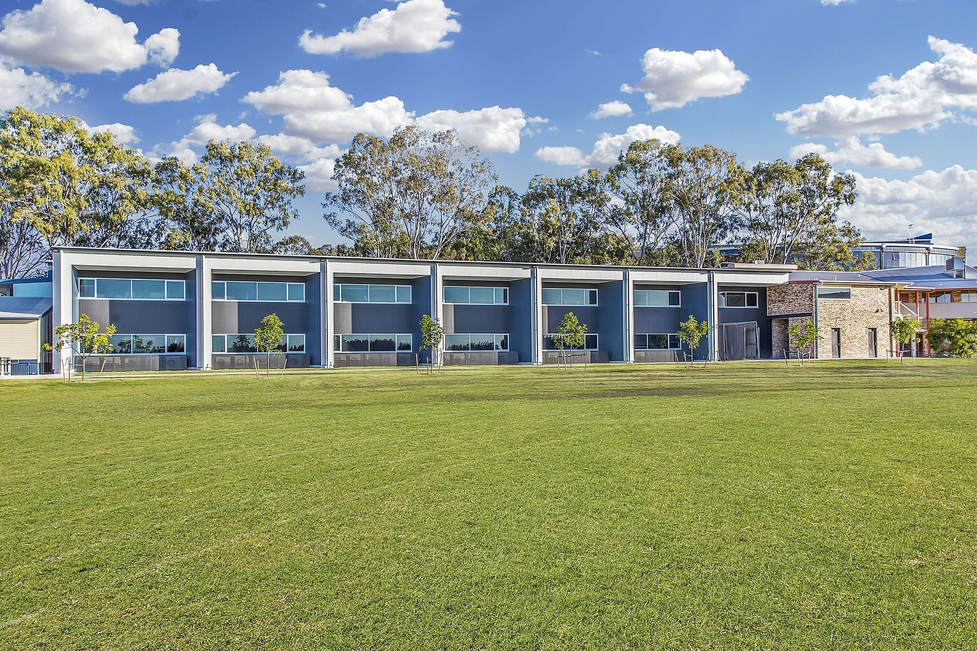 Campus buildings behind an open playing field