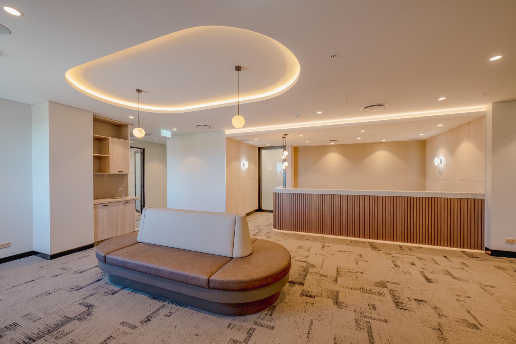Consulting suite reception with curved joinery and pendant lighting