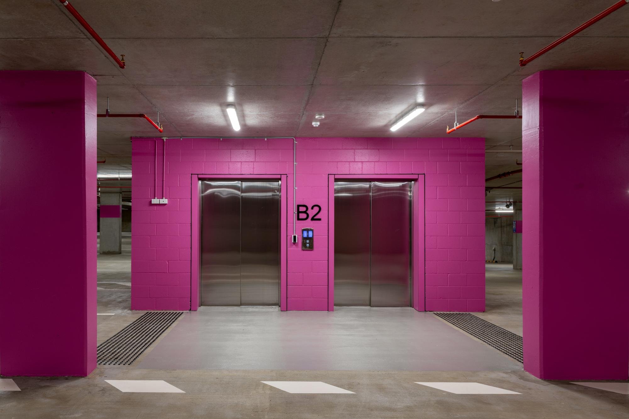 Basement lift lobby with linear lighting and services
