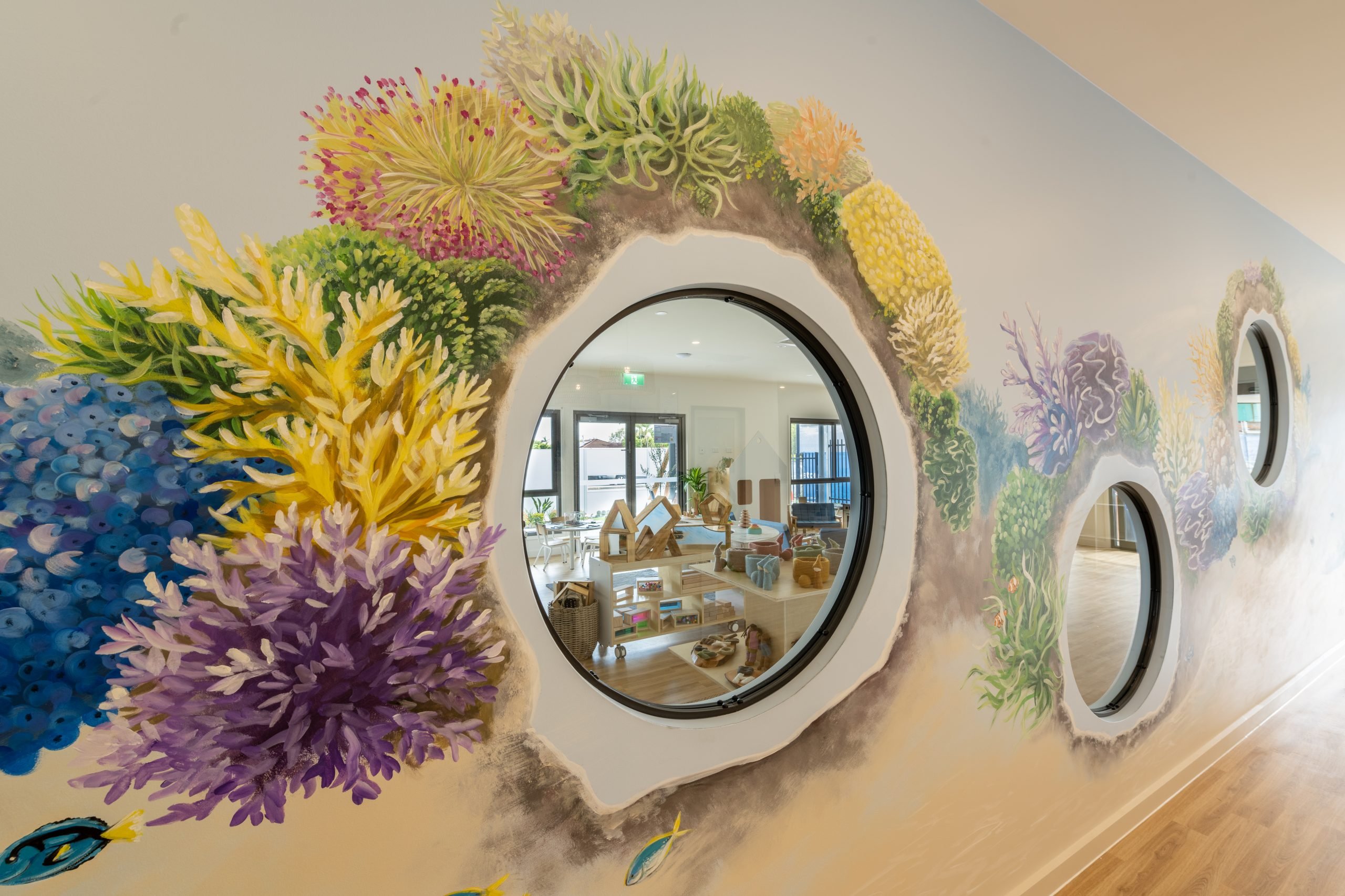 Illustrated feature wall with circular window openings