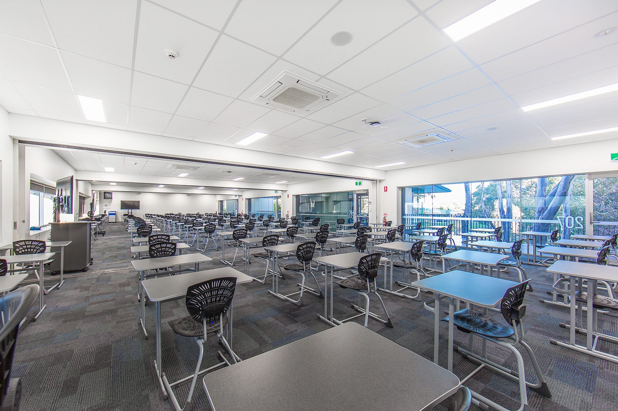 Learning space with ceiling services and workstations