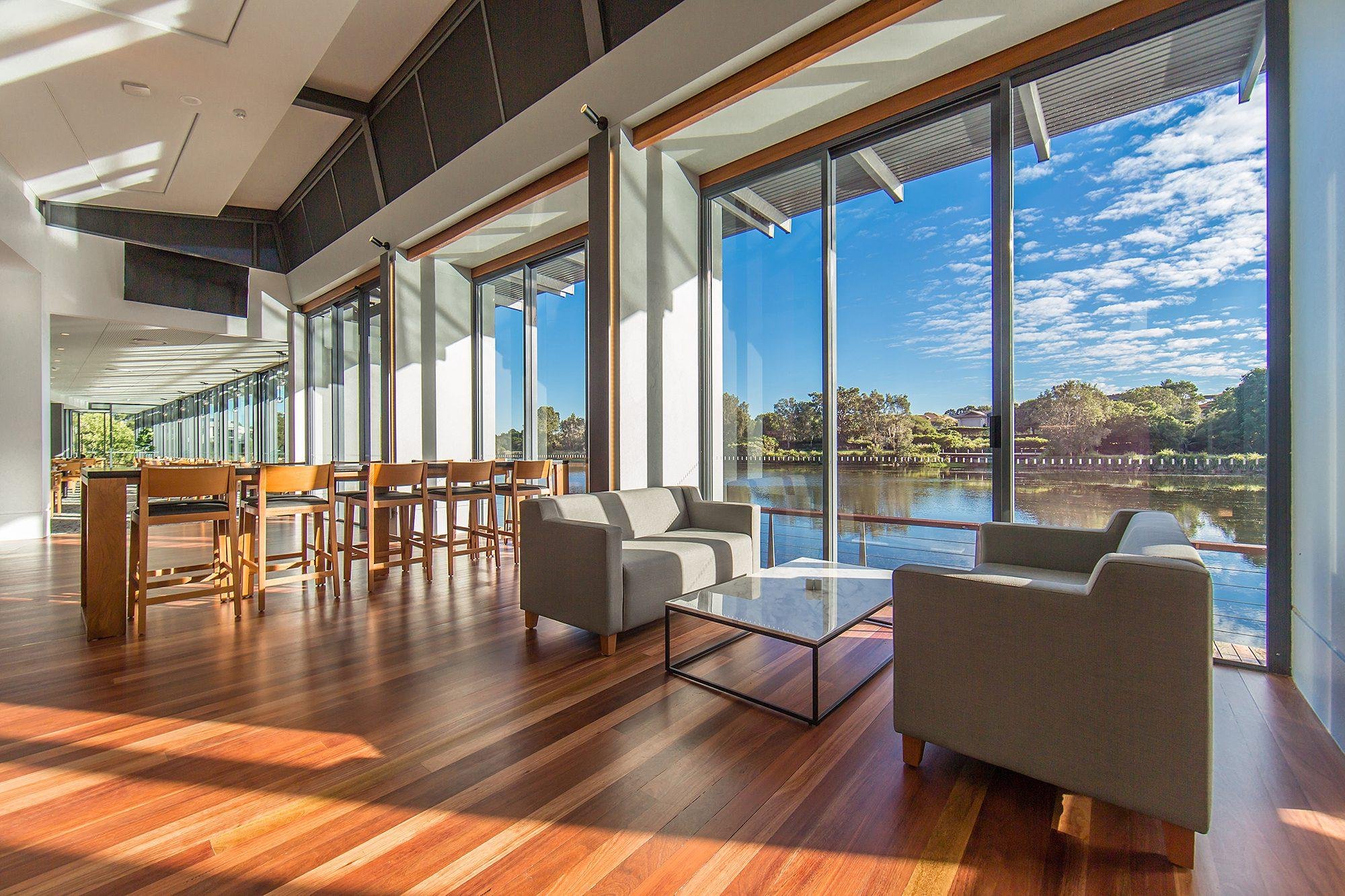 Lounge with timber flooring and lake outlook