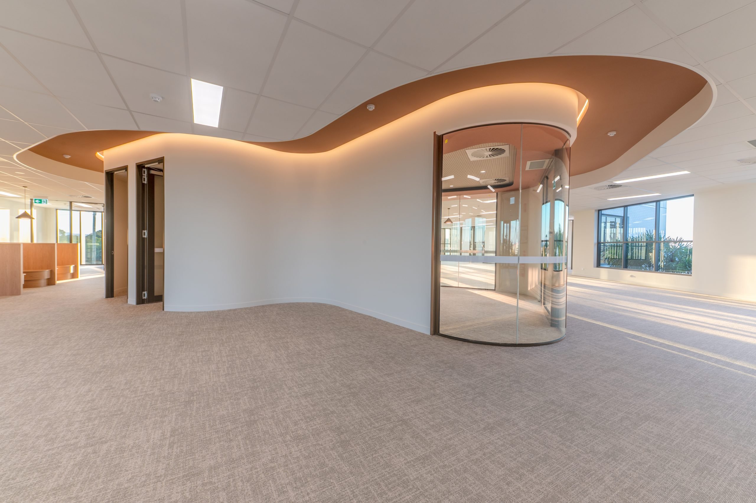 Office floor with curved feature ceiling and integrated lighting