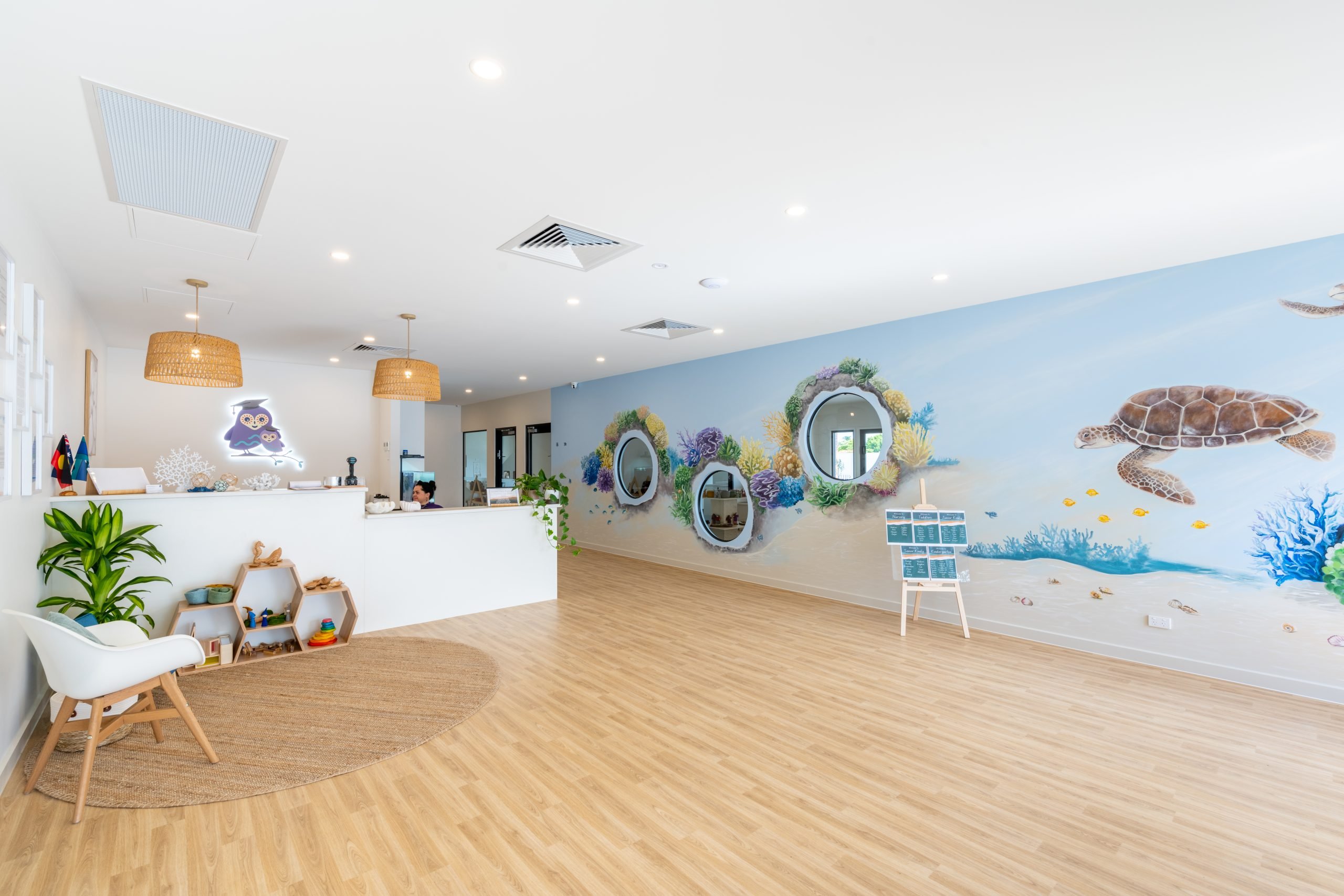 Foyer with reception desk and painted mural