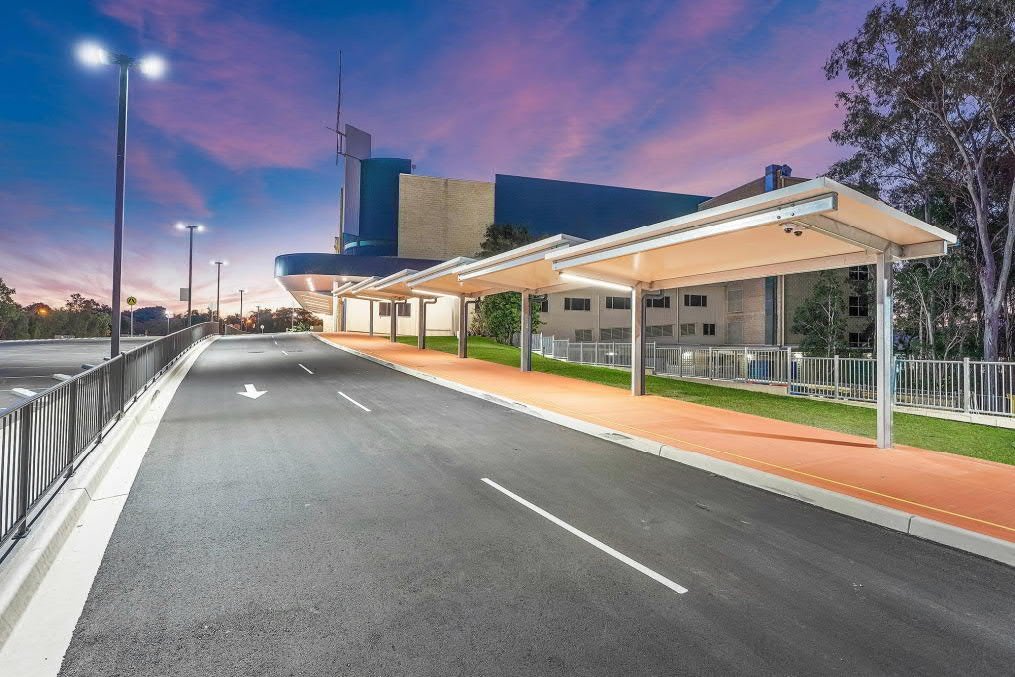 Carpark awning and roadway lighting illuminated at dusk